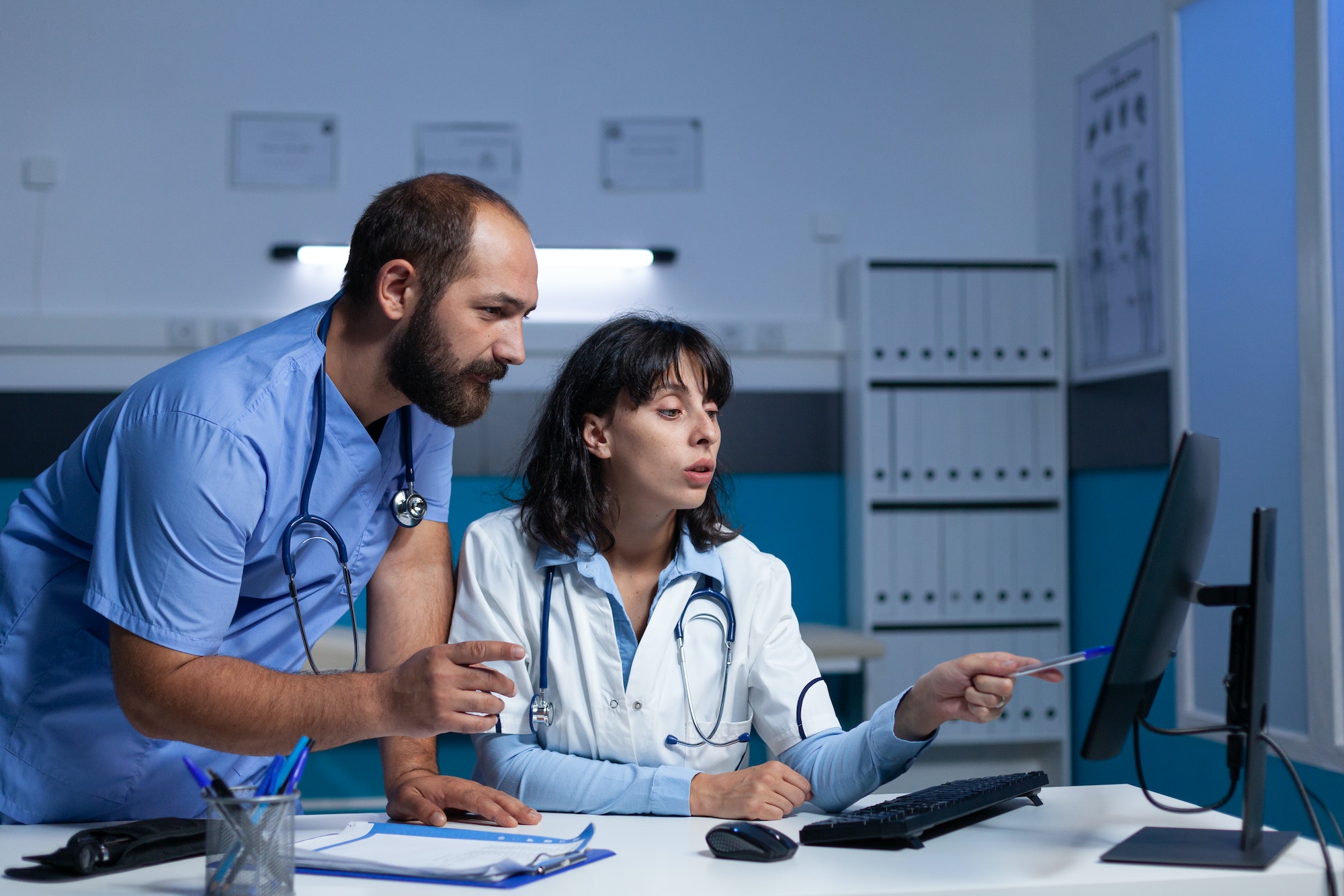Doctor and nurse pointing at computer for checkup